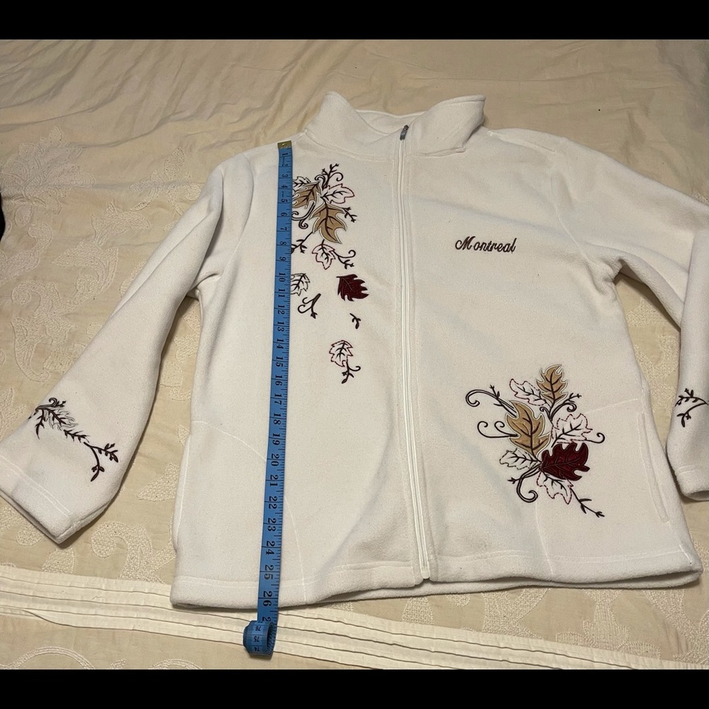 Womens White fleece zippered jacket with embroidery.